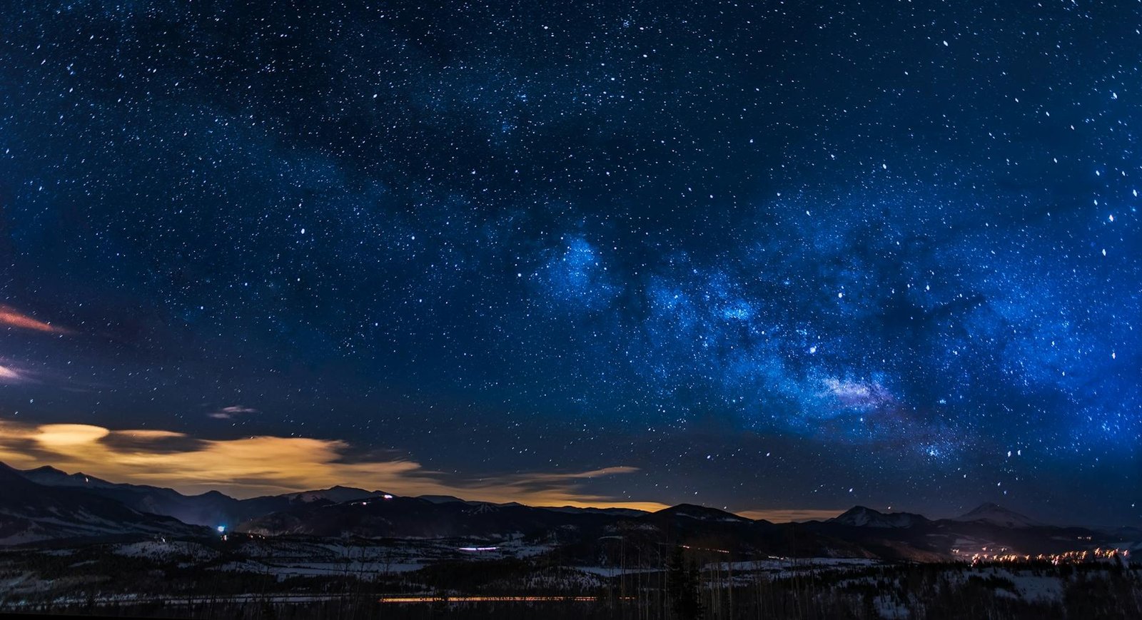 black mountains under the stars at nighttime